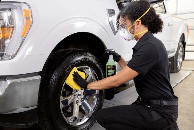 Man applying salt eliminator to a truck - representing commercial cleaning products
